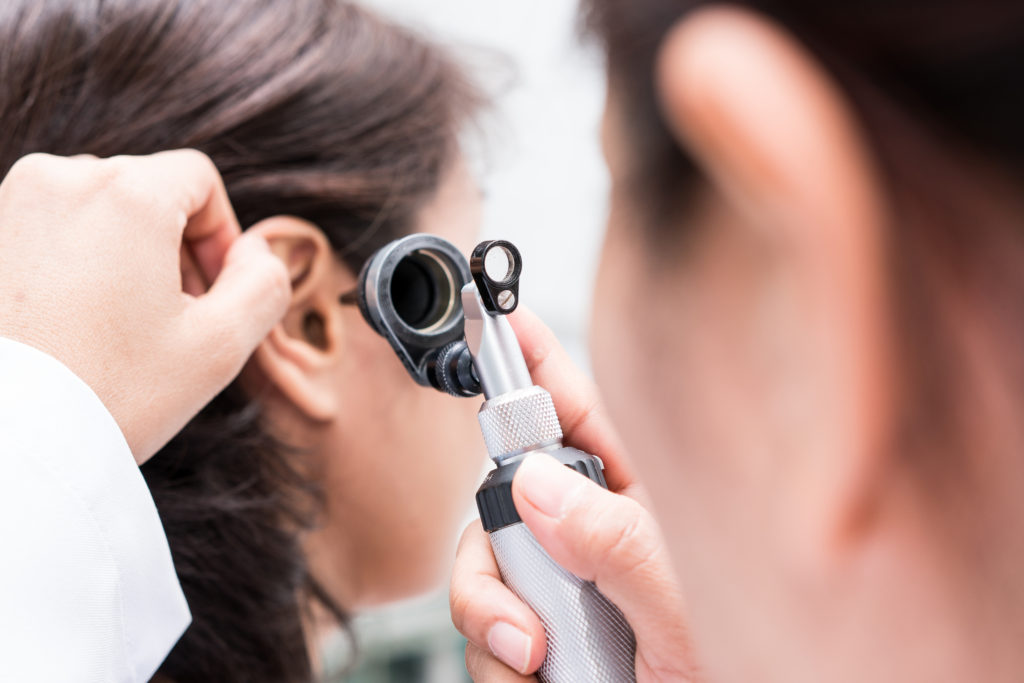 Physician checks a patient's ears